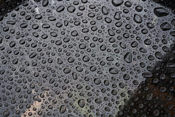 Rain drops on glass background. Raindrops on glass with reflection