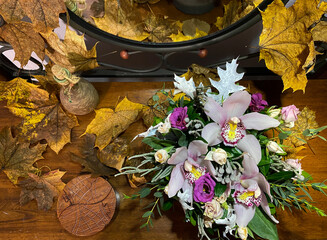 beautiful bouquet of flowers with orchids between yellow leaves