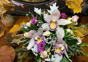 beautiful bouquet of flowers with orchids between yellow leaves