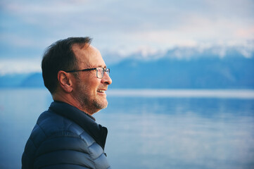Outdoor portrait of middle age man enjoying beautiful lake