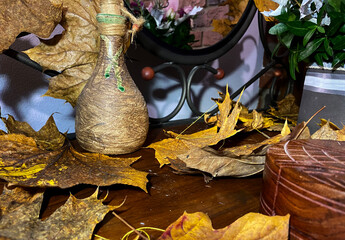 beautiful autumn leaves on a table with a mirror
