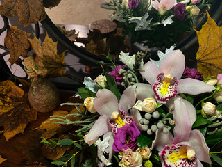 beautiful bouquet of flowers with orchids between yellow leaves