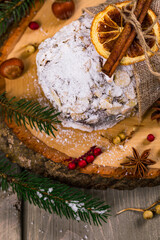 Christmas Holiday Background. Stollen, German Christmas Cake with Dried Fruits and Sliced Almonds Nuts. Selective focus.  
