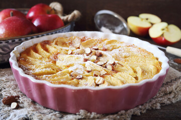 French cuisine. Red apple clafoutis, almondes and powdered sugar dressing