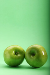 Green apples on green background