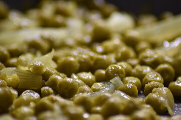 close-up of gravy with peas in a pan