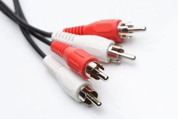 Audio and video cables on white background
