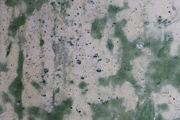 Vintage wall texture. Weathered stained rough surface of the concrete wall. A pattern with spots of...
