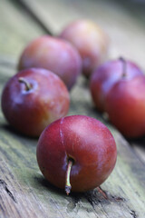 Plums on wooden table - close-up