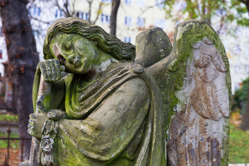 Fototapeta na wymiar Historic Statue on the autumn mystery old Prague Cemetery, Czech Republic