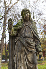 Fototapeta premium Historic Statue on the autumn mystery old Prague Cemetery, Czech Republic