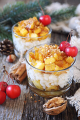 Two glass of rice milk cream  pudding with caramelized apple and praline, New Year dessert,  christmas decoration