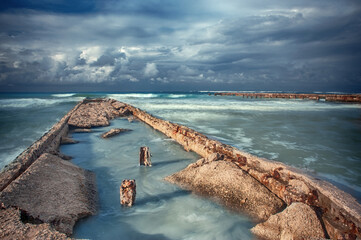 Old ruines breakwater on a beach in Cuba  - 393219077