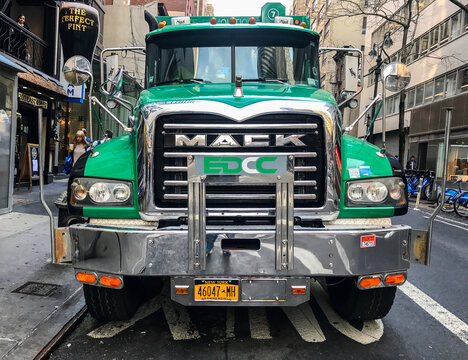 Green big and heavy truck parked in Manhattan.