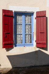 old window with red shutters