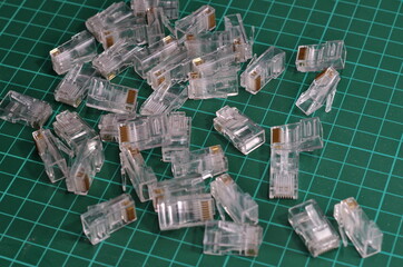 many RJ45 connector plugs on green background