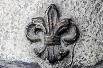 Fleur-de-lis on Antique plaster background. © jetcityimage