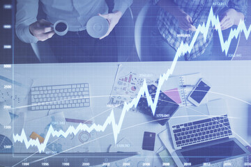 Double exposure of man and woman working together and financial chart hologram drawing. market analysis concept. Computer background. Top View.