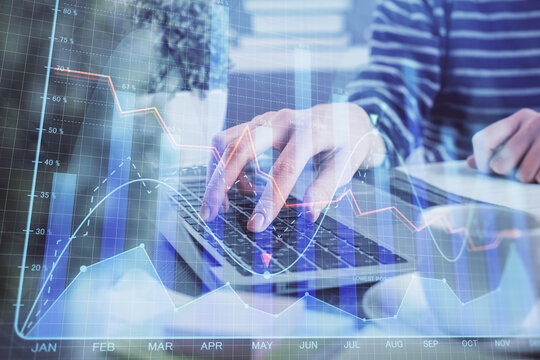 Double exposure of woman hands typing on computer and forex chart hologram drawing. Stock market invest concept.