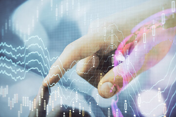 Multi exposure of man's hands holding and using a phone and financial chart drawing. Market analysis concept.