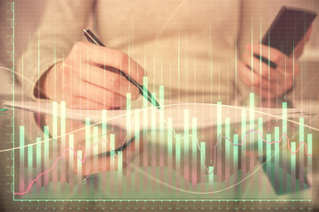 Double exposure of forex chart sketch hologram and woman holding and using a mobile device. Financial market concept.