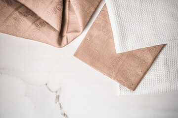 Tableware, material or cloth concept - Kitchen textile on chic white marble background, napkin and...