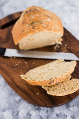simple food ingredients, homemade australian damper bread without yeast freshly made and on top of cutting board