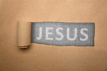 Ripped paper with Jesus text