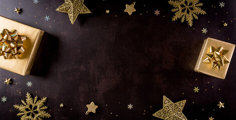 Top view of golden christmas boxes on black background with copy space for text. Black Friday Sale, Banner, poster composition.