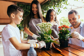 Latin family taking care of the plants at home.