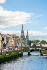 Fototapeta na wymiar Saint Fin Barre's Cathedral and south gate bridge on river Lee in Cork