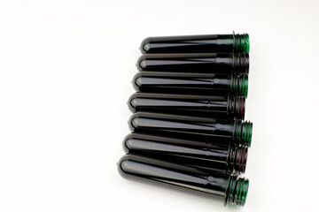 PET preforms on a white background, copy space. Blanks for creating plastic bottles.