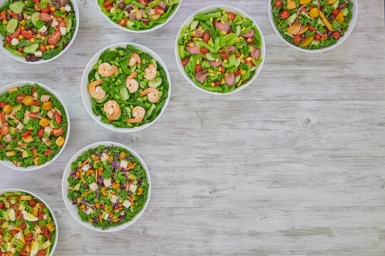 Colorful Fresh Wholesome Salads with Shrimp Edamame, Mediterranean Couscous, Roast Beef, Artichoke Ham, Grilled Chicken & Avocado and Cobb Salads.