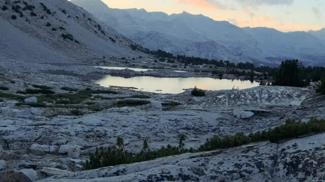 Transition into a shot of an alpine lake on the side of a rocky mountain in the Sierra Nevadas (60 fps slowed to 30 fps)