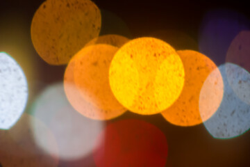 An beautiful Christmas background dark made of blurred colorful lights. Copy space