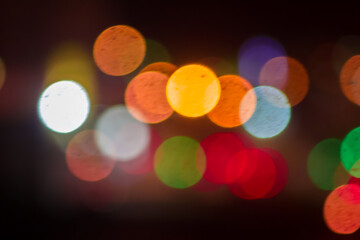 An beautiful Christmas background dark made of blurred colorful lights. Copy space
