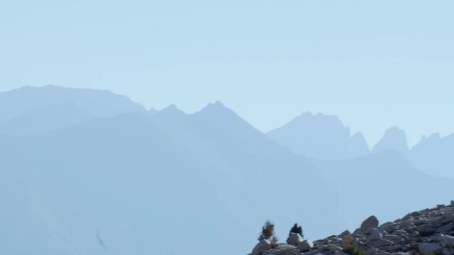 Smooth pan over layers of beautiful blue mountains along the John Muir Trail in California (60 fps slowed to 30 fps)