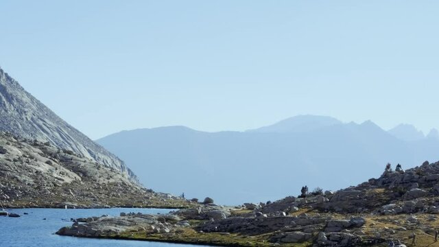 Transition slide up shot of beautiful lake along the JMT with blue mountains in the background (60 fps slowed to 30 fps)
