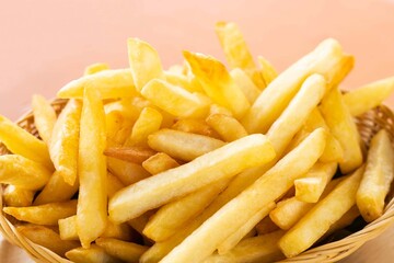 Close up Tasty French fries or potato fry  with salt served in a wooden basket.Fastfood.