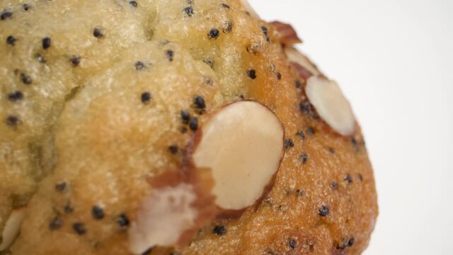 macro shot of lemon poppy seed muffin with almonds