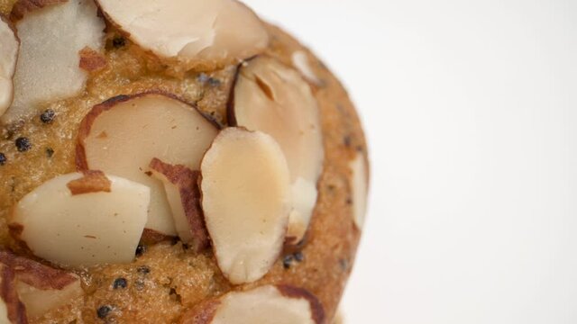 extreme closeup of lemon poppy seed muffin with almonds