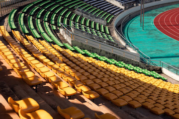 Empty stadium. Rows of yellow seats in stadium. Concept of empty stadium without spectators, quarantine time