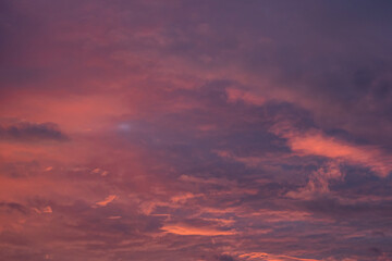 Obraz premium beautiful cloudy sky with pink, red orange and purple colour right after sunset