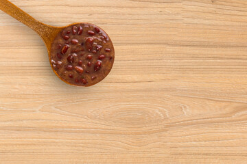 A spoon with Brazilian Feijoada Food. Top view. wooden table background. Copy sapce