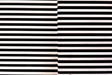 A wooden wall with white striped pattern.