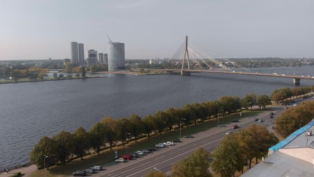 Drone aerial flying towards Vansu Bridge in Riga, Latvia on a clear day with no clouds