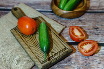 High angle view of cucumbers and tomatoes on a wooden background