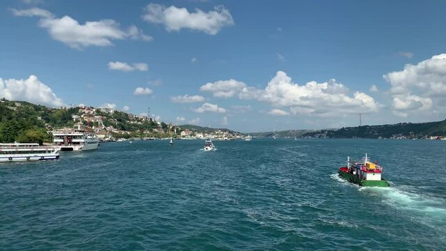 Time lapse footage of yachts and cruise tour boats passing on Bosphorus in Kurucesme / Arnavutkoy area of Istanbul. Beautiful scene. It is a cloudy / sunny summer day.