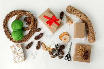 Set tools for Christmas and zero waste, eco friendly packaging gifts in kraft paper on white table, eco christmas holiday concept, eco decor banner,  2021 holiday trend, stay home