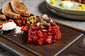 Beef tartare on wooden plate